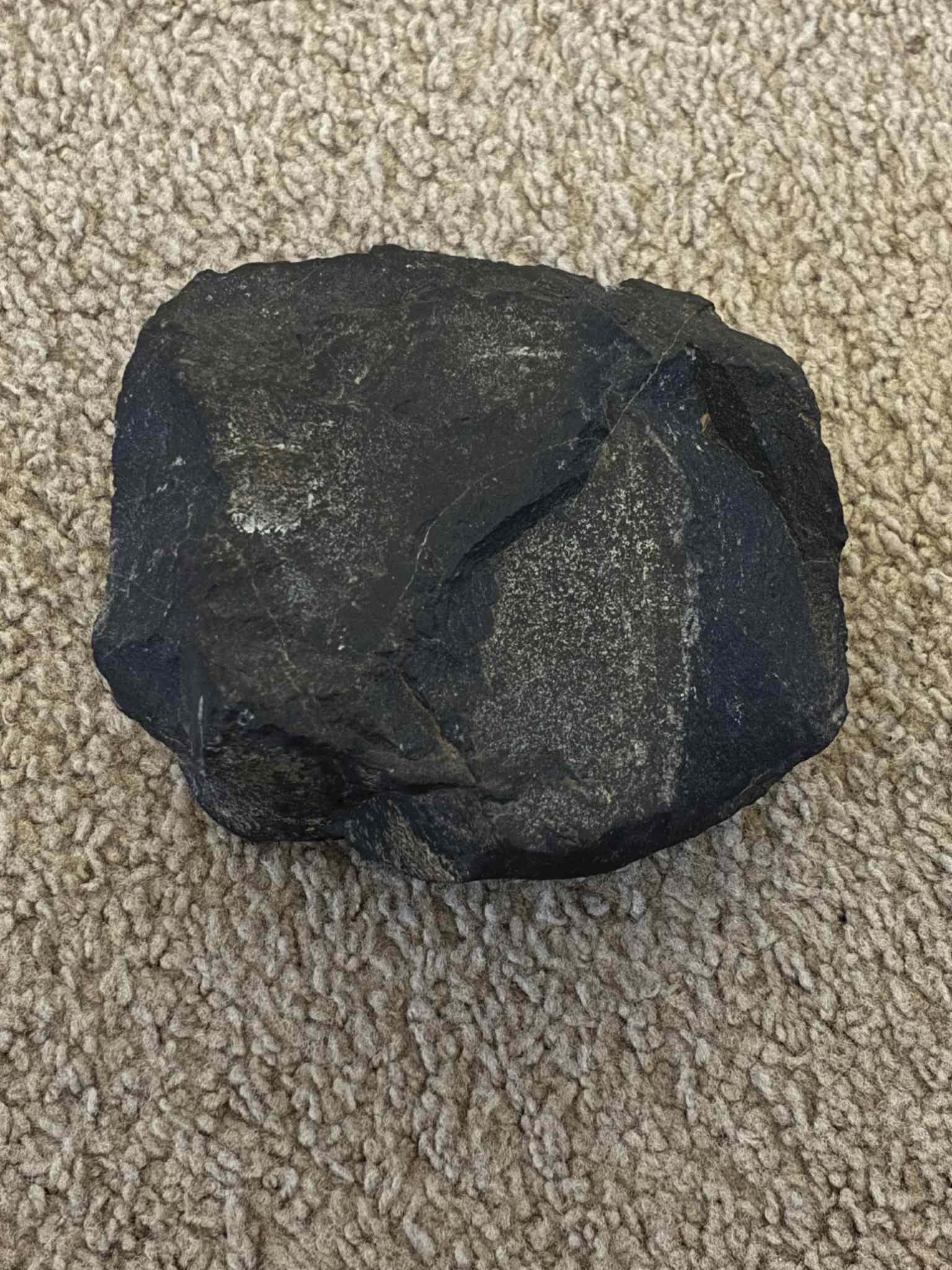 A dark fine-grained basalt specimen